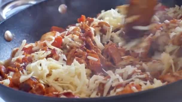 Close up on hot steaming pan on cooker stove filled with red sauce covered nutritious vegetables, chicken  melting grated cheese mixture.