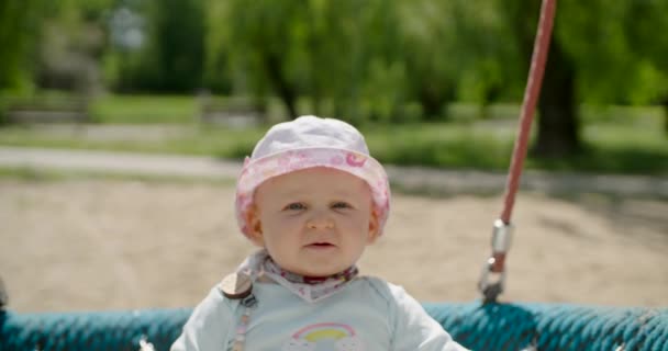 Serious Baby Girl Balançando Teeter Swing Slow Motion — Vídeo de Stock