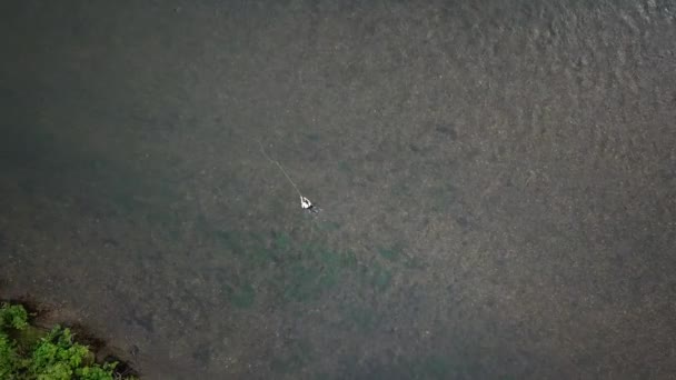 在犹他州的普罗沃河上 俯瞰鸟眼的无人机在一个人的头顶上鸣枪 这个人正在抛掷他的飞竿 — 图库视频影像