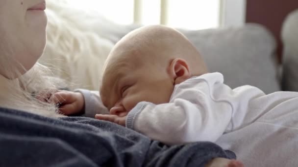 Νεαρή Μητέρα Αγκαλιάζει Νεογέννητο Αγοράκι Ξαπλωμένο Στον Αναπαυτικό Καναπέ — Αρχείο Βίντεο