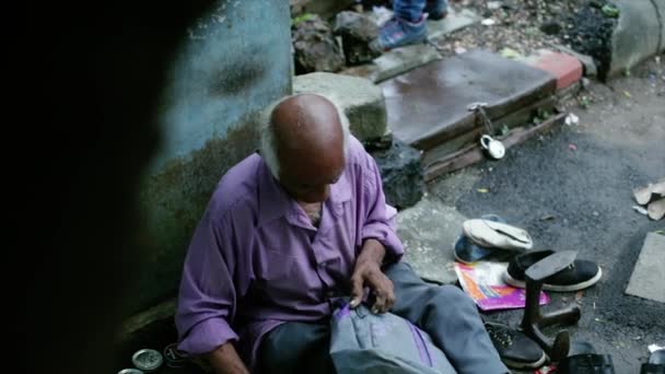 Seorang Tukang Sepatu Memperbaiki Sandal Peziarah Pinggir Jalan Dalam Koleksi — Stok Video