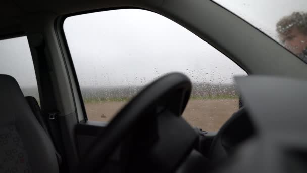 Człowiek Patrzący Przez Okno Wycierający Okno Samochodzie — Wideo stockowe