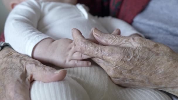 Closeup Grandmothers Wrinkled Hands Holding Newborn Baby Tenderness Love Affection — Stock Video