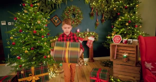 Young Box Holds His Christmas Present While Spinning His Hands — Stock Video