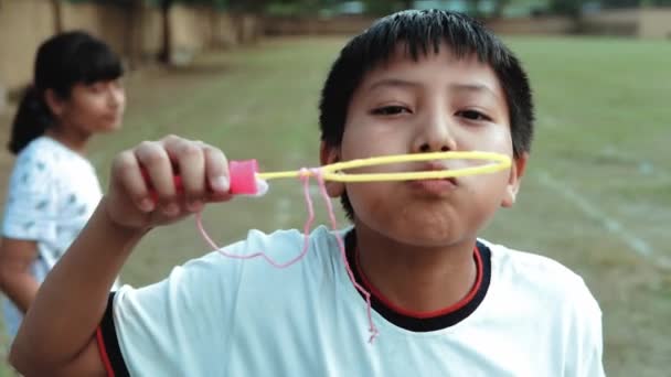 Static Slow Motion Shot Boy Blowing Soap Bubbles School Yard — Stock Video