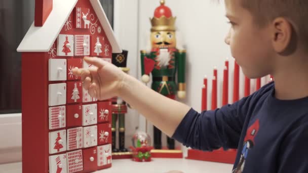 Happy Little Boy Takes Sweet Advent Calendar House Form Christmas — Stock Video