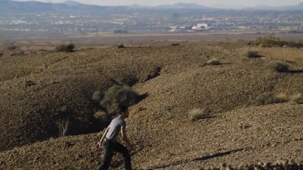 Young Man Makes His Way Desert Landscape Reveal Las Vegas — Stock Video