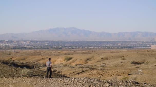 Young Man Makes His Way Las Vegas Valley Hilly Desert — Stock Video