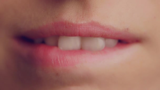 A woman biting her lower lip then releasing it - Close up