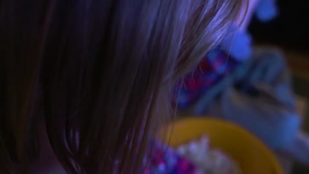 Közelkép Egy Kislányról Aki Popcornt Töm Szájába Miközben Tévét Néz — Stock videók