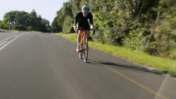 Tracking Shot Young Male Road Cyclist Racing Hill — Stockvideo