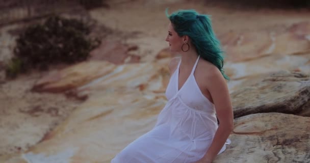 Alluring Gen Woman White Dress Blue Hair Sitting Sandstone Rock — Stock Video