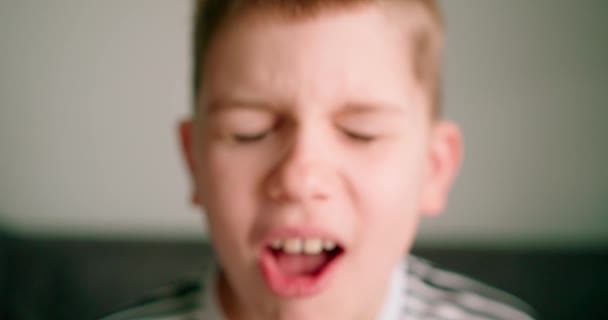 一个小孩张大嘴咳嗽的近景 在灰色背景上隔离 — 图库视频影像