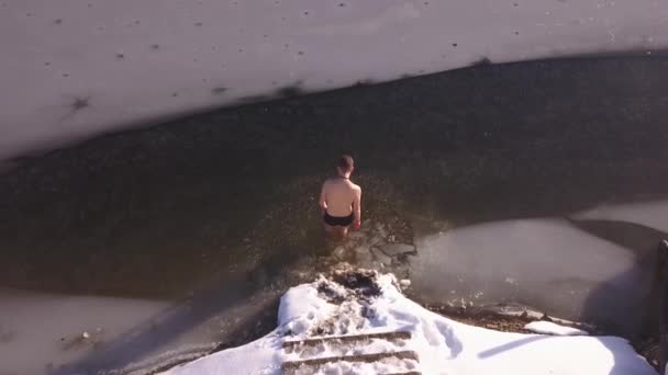 Aerial View Young Man Entering Frozen Lake Winter Broken Ice — Stock Video