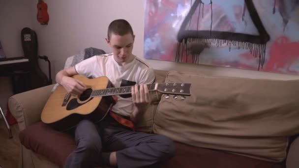 Jeune Homme Confortablement Assis Sur Canapé Tout Jouant Guitare Gros — Video