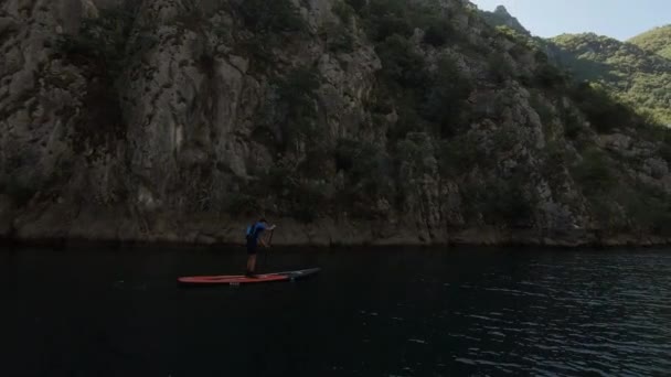 Skjuten Ung Man Som Står Upp Och Paddlar Längs Flod — Stockvideo