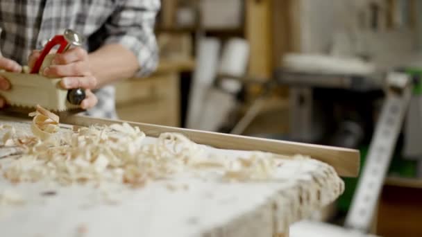 Male Checkered Shirt Uses Hand Plane Slice Thin Layer Wood — Stock Video