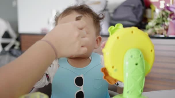 Beautiful Asian Baby Eating Solid Foods Looking Camera Curiosity — Stock Video