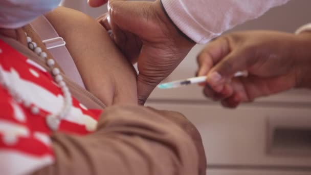 Elderly African Woman Seated Chair Gets Vaccinated Nurse Arm Close — Stock Video