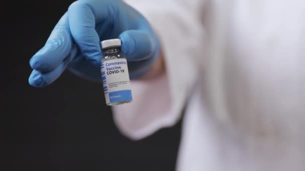 A Doctors Hand Presents A Vial of Vaccination