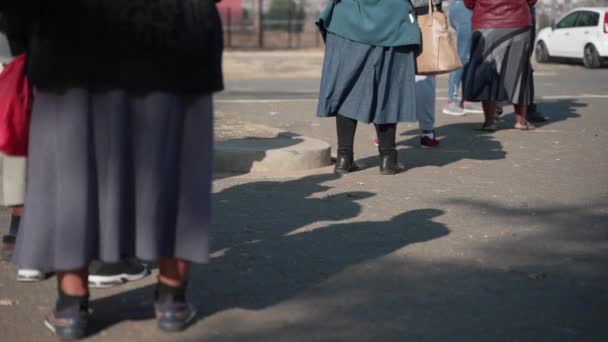 Elderly African Women Stand Long Queue Waiting Outdoors Skirts Blow — Stock Video