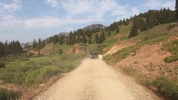 POV while following a 4WD vehicle onto the start of Black Bear trail through the San Jan Mountains near Telluride Colorado; concept of adventure and adrenaline rush
