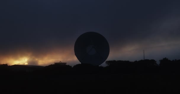 シルエット軍用レーダー皿暗い日没の雲の背景と — ストック動画