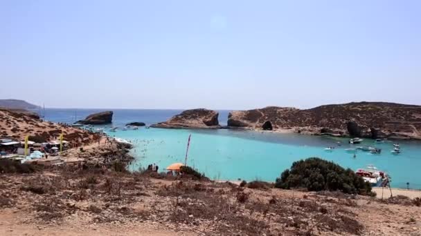 マルタのコミノ島 マルタのコミノ島の青いラグーンで泳ぐ観光客 人気のスポットで 観光客で賑わっています — ストック動画