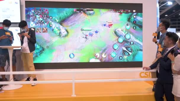香港で開催されるAnicom Games Acghkの展示会では スマートフォンでライブストリーミング配信されるため 来場者はビデオゲームをプレイします — ストック動画