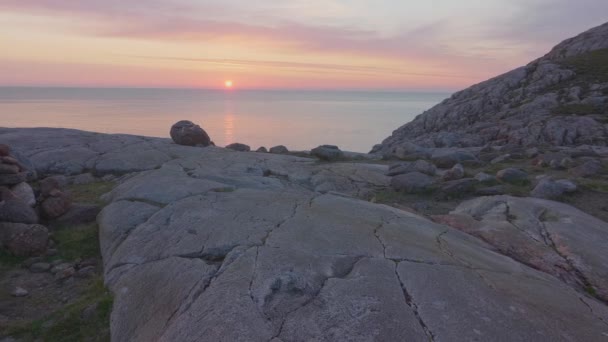 山の頂上に作られた岩のバランスのとれた彫刻 美しいピンクの夕日と澄んだ空で穏やかな海を見下ろす — ストック動画