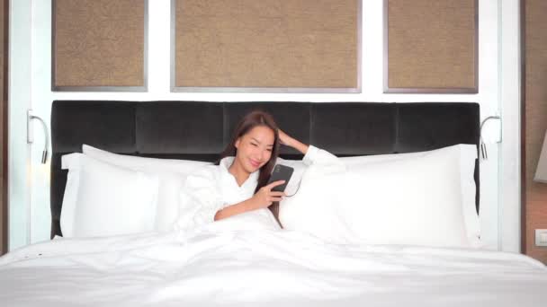 Beautiful Woman Bed Looking Smartphone Smile Bright Morning Full Frame — стокове відео
