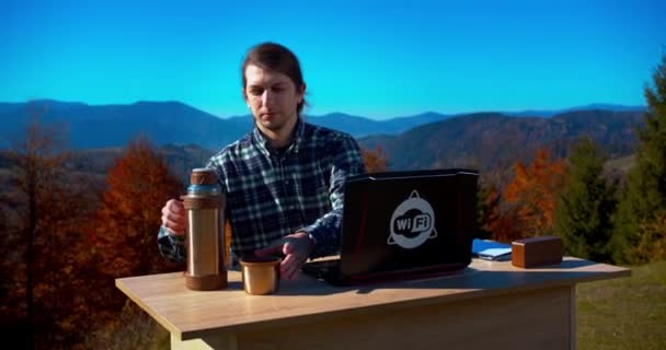 Freelancer Man Drinking Tea Thermos While Working Laptop Table Mountains — Stock Video