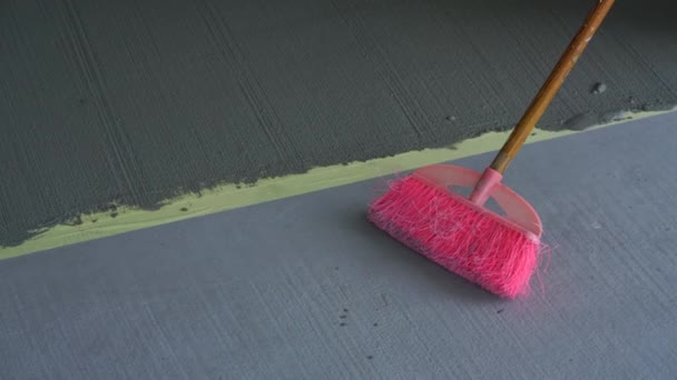 Pink Broom Next Fresh Cement Textured Floor Renovation Construction — Stock Video