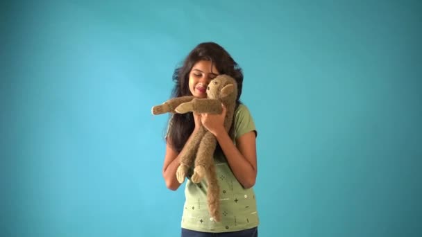 Young Indian Girl Green Shirt Cuddling Monkey Doll Standing Isolated — Stock Video