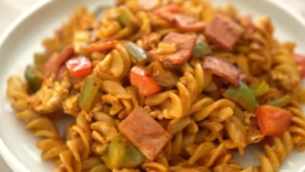 stir fried fusilli pasta with ham and tomatoes sauce
