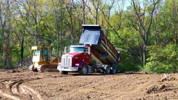 Red Dump Truck Unloading Dirt Yellow Bulldozer Waiting Level Load — Stock Video