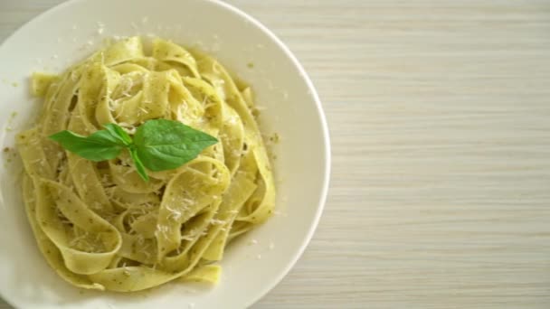 pesto fettuccine pasta with parmesan cheese on top - Italian food style
