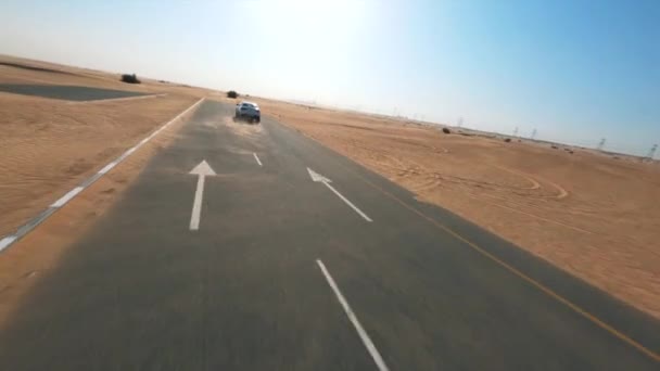 Fpv Drone View Flying White Car Driving Dusty Desert Road — Stock Video