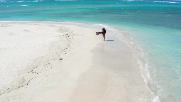 无人机飞过比基尼和沙隆的女性游客 在热带白沙滩上 碧绿的水面上 — 图库视频影像