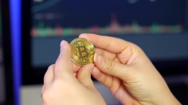 Mulher Irreconhecível Segurando Olhando Para Bitcoin Seus Dedos Frente Gráficos — Vídeo de Stock