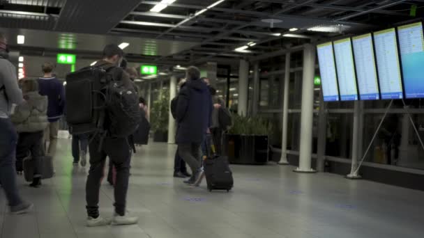 Passengers Look Flight Information Displayed Schedule Boards Departure Terminal Amsterdam — Stock Video