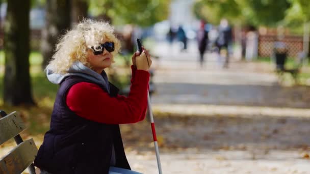 Blind Woman White Cane Sitting Park Bench Medium Shot — Stock Video