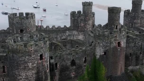 歴史的Conwy城ランドマークタウン廃墟石の壁の戦いの空中ビュー右上昇観光名所軌道 — ストック動画