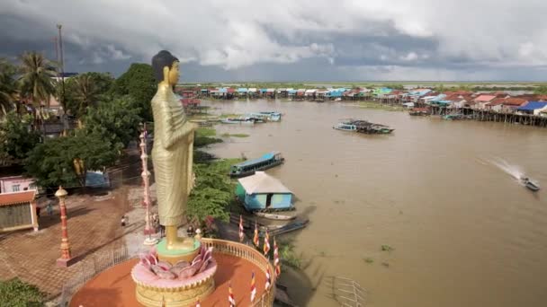 東南アジアのモンスーン期に浸水した村を見下ろす巨大な仏像 カンボジア カンポン クランの守護者 — ストック動画