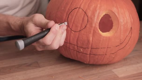 Person Carves Eyes Jack Lantern Pumpkin Closeup — Stock Video