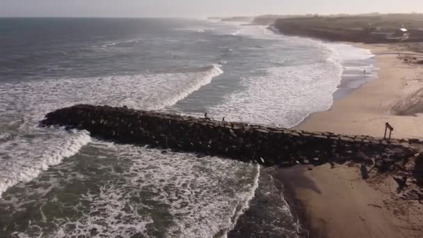 Aerial Drone Shot Tourist Walking Rocky Jetty Crashing Waves Ocean — Vídeos de Stock