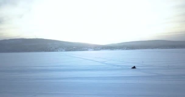 Person Riding Snow Mobile Snowy Field Med Bjergudsigt Kiruna Sverige – Stock-video