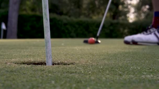 Golfer Hit Rode Golfbal Het Gat Met Putter Golfbaan Sluiten — Stockvideo