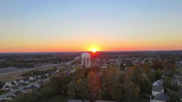 Bright Orange Sunset Residential Houses Water Tower Aerial Approach — Stock Video