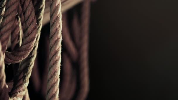 Close Rope Hanging Wooden Plank Dark Background Slow Pan — Stock Video